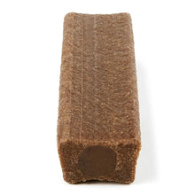 Brown dog chew bone piece standing upright with dark end cutout