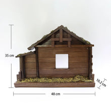 Nativity stable ornament with grass base, wooden shelter, and arched front window