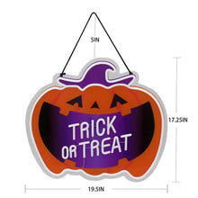 Neon pumpkin wall sign “Trick or Treat” with purple lettering and orange design