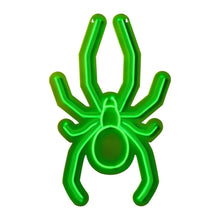 Green neon spider wall decor, close-up front view with outlined legs