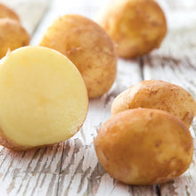 Potatoes with one peeled half and several unpeeled tubers