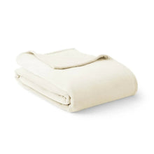 Oversized cloud-touch blanket folded in ivory