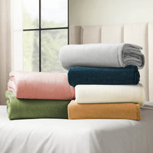Oversized cloud-touch blanket stack in blush, cream, gray, and green tones