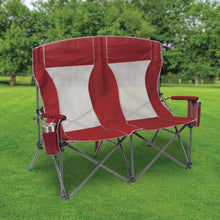 Red oversized double chair with white back panels and gray metal frame, cup holder