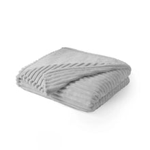 Oversized plush blanket in light gray, folded with ribbed stripe texture