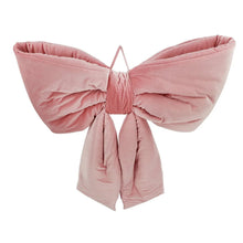 Oversized velvet bow decor with rounded pink velvet wings and tied hanging ribbons