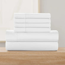 Solid white sheet set, folded flat with neatly stacked layers