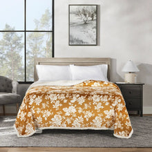 Plush blanket with orange floral print and white oversized blossoms