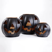 Three black metal jack-o-lantern lanterns, front view, with orange cutout face designs