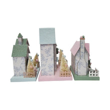 Set of 3 pre-lit paper houses with green, blue, and pink roofs and pine tree accents
