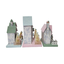 Front-facing set of 3 pastel paper houses with snowy-texture walls and tree details