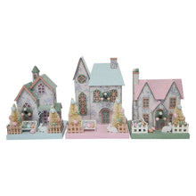 Set of three pastel paper houses with blue, green, and pink roofs and snowy texture