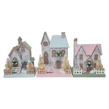 Three pastel paper houses: one blue-roof, one green-roof, one pink-roof