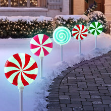 Peppermint stake lights set of 5 with colorful lollipop heads, lit on outdoor walkway
