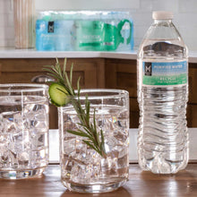 Purified water bottles beside clear glasses filled with ice and rosemary