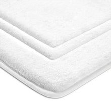 White bath mat corner with plush memory foam and curved, padded edge