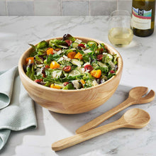 Rubber wood salad bowl with two matching servers beside it