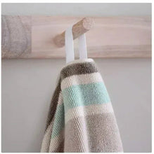 Striped beach towel corner with teal center stripe and beige textured weave