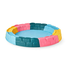 Children's inflatable sandbox ring with blue, pink, yellow and teal padded blocks.
