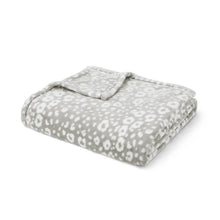 Folded gray lounge throw blanket with allover white animal-print pattern