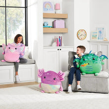 Purple-pink squishy plush with sparkly belly and fins, placed on living room floor.
