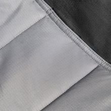 Swing lounger camp chair fabric close-up with stitched panel and textured weave.