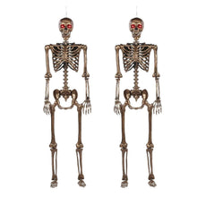 Gold-tone skeleton decoration set with glowing red eyes, full body front view