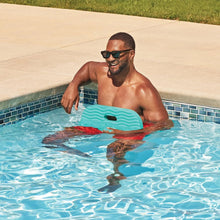 Teal floating pool saddle in the water with two recessed handle openings