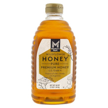 Wildflower honey bottle with amber honey and gold cap, front label