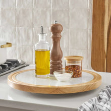 Wood-and-marble lazy susan with marble top and light wood rim, set with oil and pepper