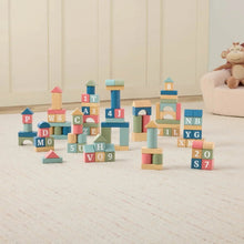 Wooden building blocks arranged in rows, featuring lettered cubes and cylindrical pieces