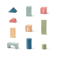 Wooden alphabet building blocks: flat wedges, rounded blocks, and lettered cube pieces