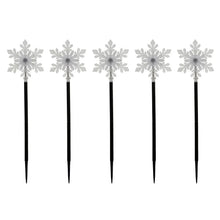 Snowflake LED pathway lights with glowing white snowflake toppers on black stakes