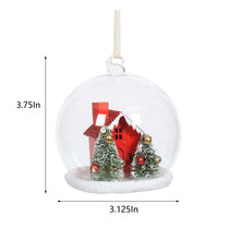 Clear bulb ornament with snowy village scene, pine trees, and red house