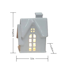 White lit holiday house ornament front view with warm window lights