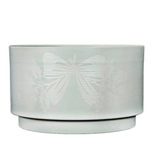 Pre-lit topiary base with frosted light-blue drum and embossed bow design