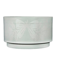 White topiary planter base with embossed bow detail and pedestal
