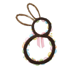 Close-up bunny-shaped twig wreath with multicolor beads and pink ribbon bow