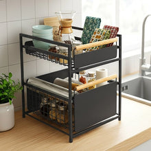 Black two-tier organizer holding kitchenware, jars, and coffee filters