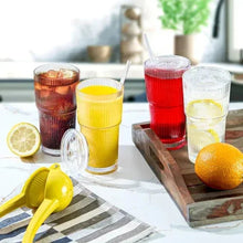 Set of ribbed glass cups with straws in yellow, red, and clear tones