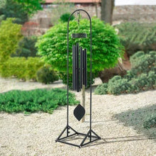 Metal wind chime stand, black arched frame with hanging chime and triangular base.