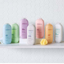 Assorted Method body wash bottles in light green, pink, and white on display