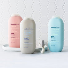 Body wash bottles in pink, white, and blue with printed scent labels