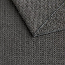 Gray microfiber kitchen towel with textured weave and stitched hem, folded.