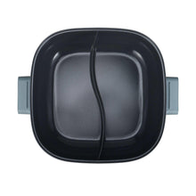 Top view of dual-zone electric hot pot interior with raised divider