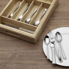 Stainless steel flatware on plate with wood caddy, assorted forks spoons knives