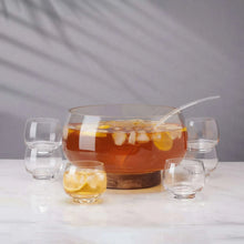Glass punch bowl with wooden base, ladle, and six small clear cups