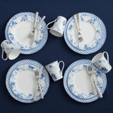 Bone china dinnerware with blue floral and grid plates, cups, and matching bowls
