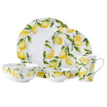 White dinnerware set with yellow lemon and green leaf pattern, large plates and mugs