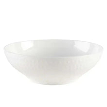 White serving bowl with textured exterior and smooth interior.